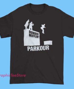 A humorous T-shirt design featuring the Dunder Mifflin logo with a playful illustration of characters performing parkour moves.