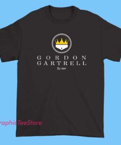 A stylish shirt featuring a prominent logo with a crown symbol and the text 'EST 1984' above the name 'Gordon Gartrell' in bold lettering, conveying a vintage-inspired, designer-inspired aesthetic
