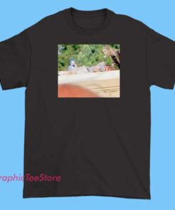 A graphic T-shirt featuring bold text that reads 'Tuah is Not Dead,' with references to Art Hawk and Cernovich's Twitter presence. The design may include stylized portraits or icons representing social media, along with motivational or rebellious elements centered around the themes of resilience and online activism.