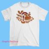 A T-shirt featuring the 'Single Fin Tour' and 'Her Waves' theme, likely showcasing surf-inspired artwork.