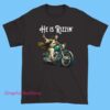 Funny He Has Rizzen Jesus Riding Motorcycle Shirt featuring humorous Jesus-on-motorcycle graphic, perfect for spiritual apparel fans and riz meme streetwear styles.