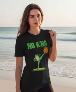 Funny frog protest no king shirt featuring cartoon frog holding anti monarchy sign, humorous political satire graphic tee, viral meme frog design for activists, streetwear fans, and freedom lovers.