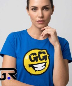 Fortnite GG Emoji Smiley Face Blue T-Shirt featuring playful gaming artwork, cheerful smiley design, cotton short sleeve style, and video game inspired fashion.